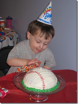 eager to dig into his baseball birthday cake